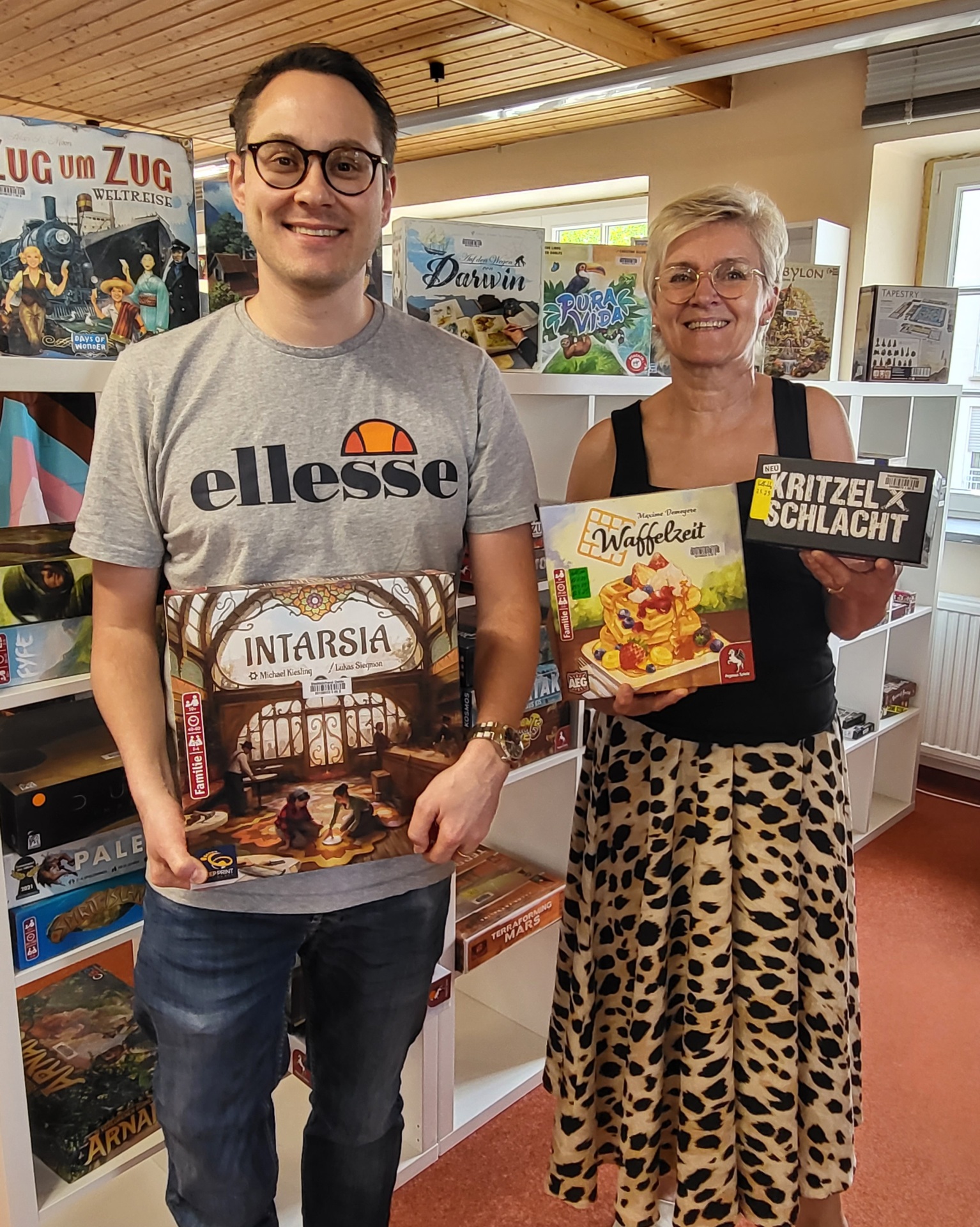 Philipp Helmers und Irmgard Weisner, Mitarbeiter*innen aus der Stadtbibliothek mit coolen Brettspielen